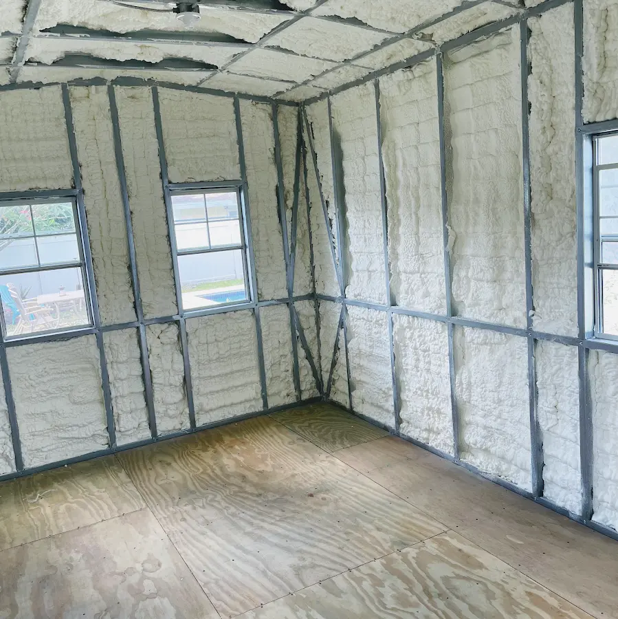 Closed-cell spray foam insulation applied to wall cavities in a residential project in Neptune